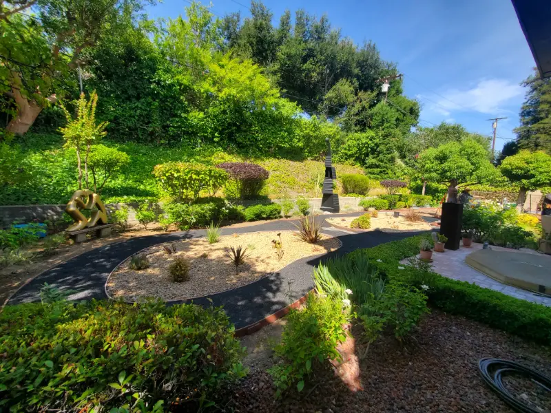 Sustainable landscape design: a garden of lawn, boulders and curved native planting beds