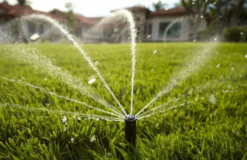 Water Saving Water-saving irrigation: a sprinkler head watering a lawn